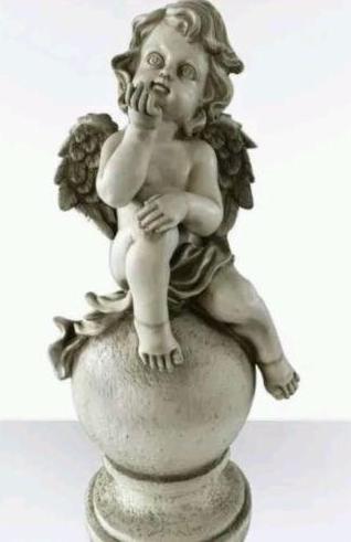 Cherub On Ball Blowing