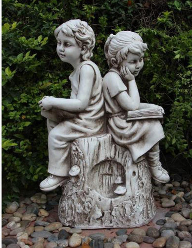 Boy Girl Reading On Rock